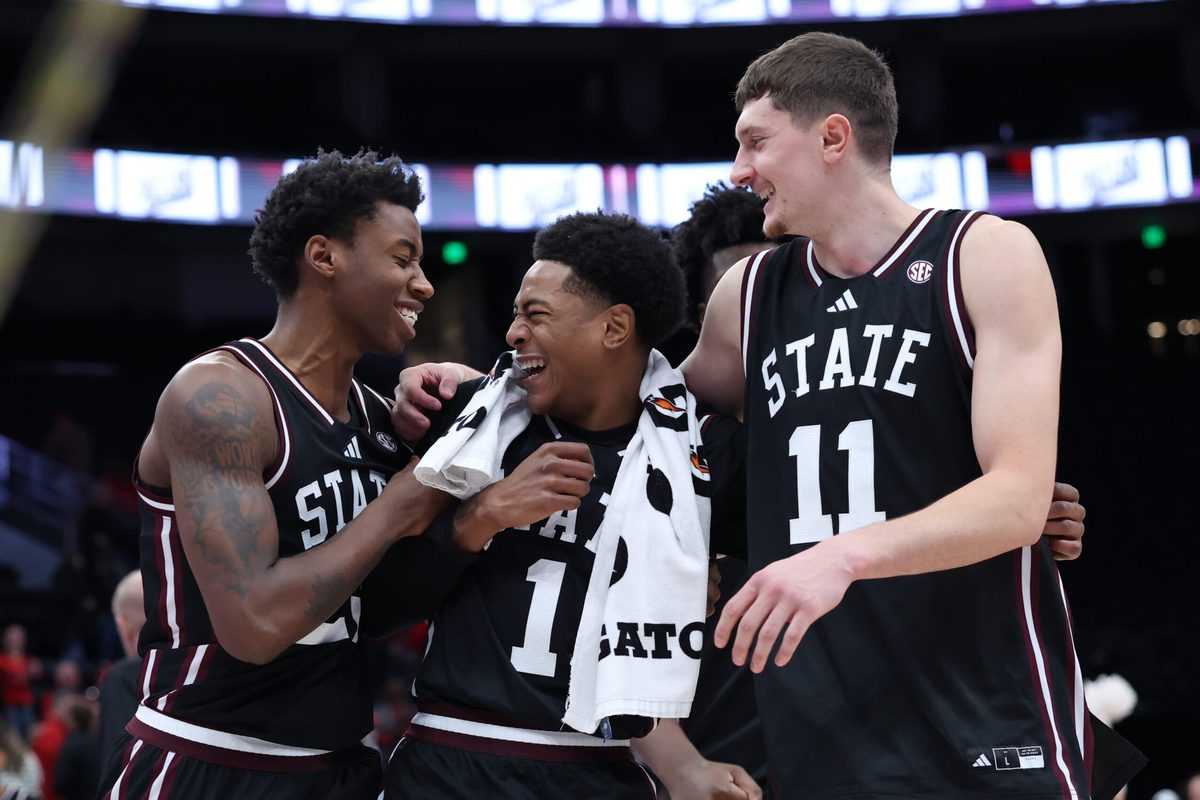 Dec 13, 2025; Salt Lake City, Utah, USA; Mississippi State Bulldogs guard King Grace (23) along with guard Dellquan Warren (1) and forward Sergej MacUra (11) celebrate a win over the Utah Utes after the game at Delta Center. Mandatory Credit: Rob Gray-Imagn Images