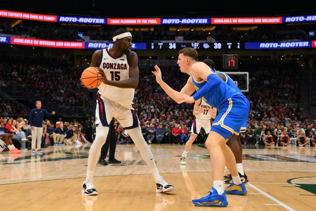 Dec 13, 2025; Seattle, Washington, USA; Gonzaga Bulldogs forward Graham Ike (15) is guarded by UCLA Bruins forward Tyler Bilodeau (34) during the first half at Climate Pledge Arena. Mandatory Credit: Steven Bisig-Imagn Images