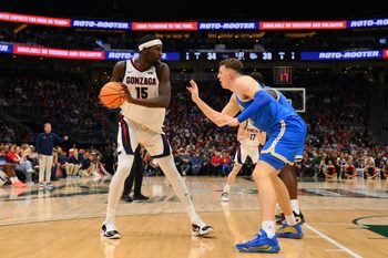 Dec 13, 2025; Seattle, Washington, USA; Gonzaga Bulldogs forward Graham Ike (15) is guarded by UCLA Bruins forward Tyler Bilodeau (34) during the first half at Climate Pledge Arena. Mandatory Credit: Steven Bisig-Imagn Images