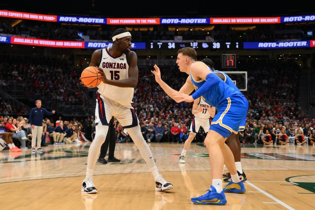Dec 13, 2025; Seattle, Washington, USA; Gonzaga Bulldogs forward Graham Ike (15) is guarded by UCLA Bruins forward Tyler Bilodeau (34) during the first half at Climate Pledge Arena. Mandatory Credit: Steven Bisig-Imagn Images