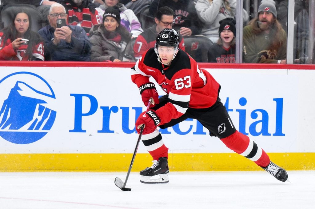 Dec 14, 2025; Newark, New Jersey, USA; New Jersey Devils left wing Jesper Bratt (63) skates with the puck against the Vancouver Canucks during the second period at Prudential Center. Mandatory Credit: John Jones-Imagn Images