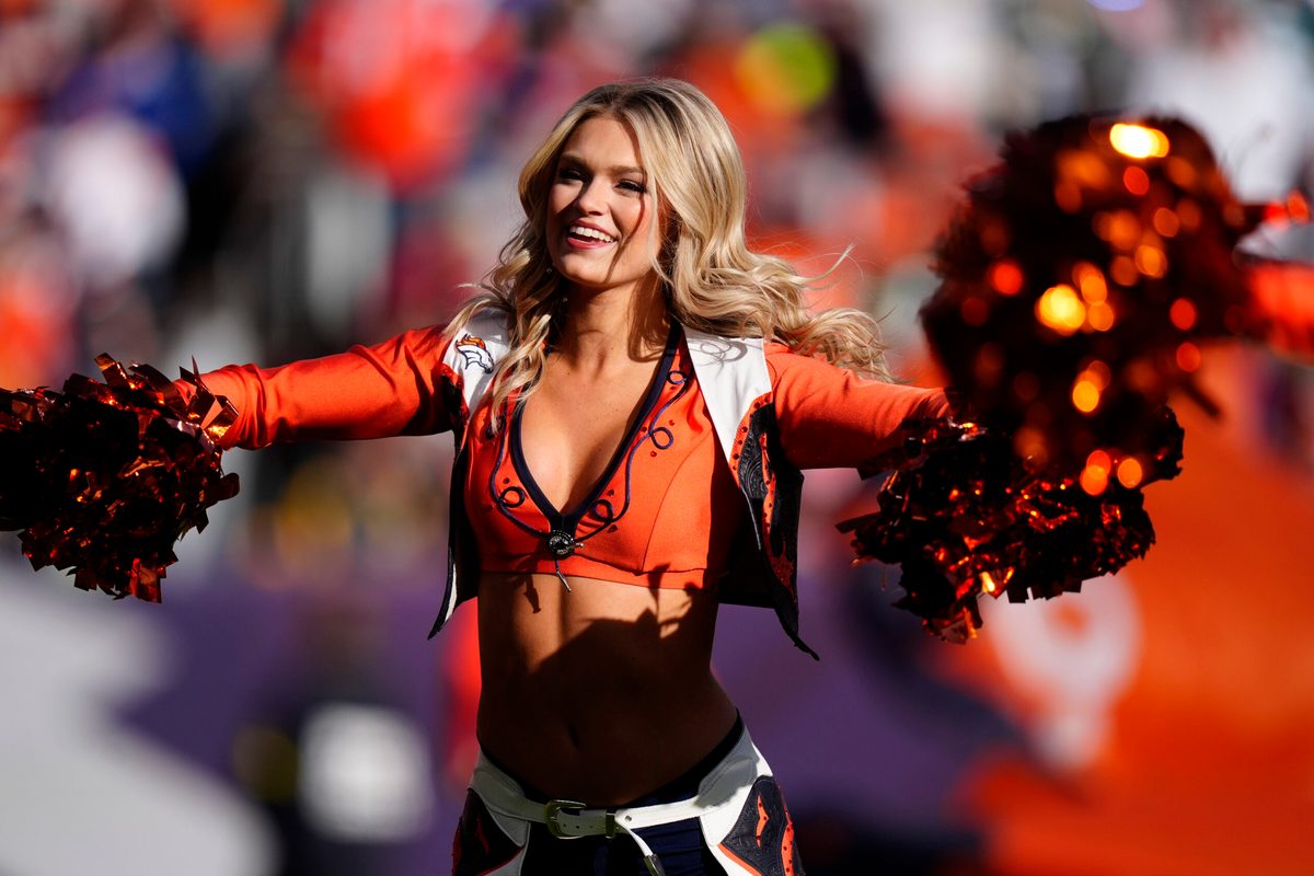 Dec 14, 2025; Denver, Colorado, USA; A Denver Broncos cheerleader performs prior to a game against the Green Bay Packers at Empower Field at Mile High. Mandatory Credit: Ron Chenoy-Imagn Images