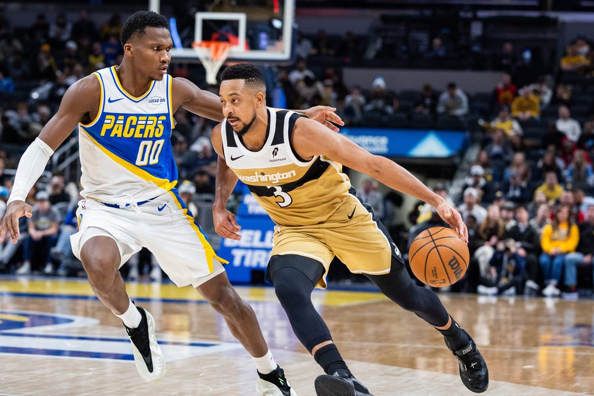 Dec 14, 2025; Indianapolis, Indiana, USA; Washington Wizards guard CJ McCollum (3) dribbles the ball while Indiana Pacers guard/forward Bennedict Mathurin (00) defends in the second half at Gainbridge Fieldhouse. Mandatory Credit: Trevor Ruszkowski-Imagn Images