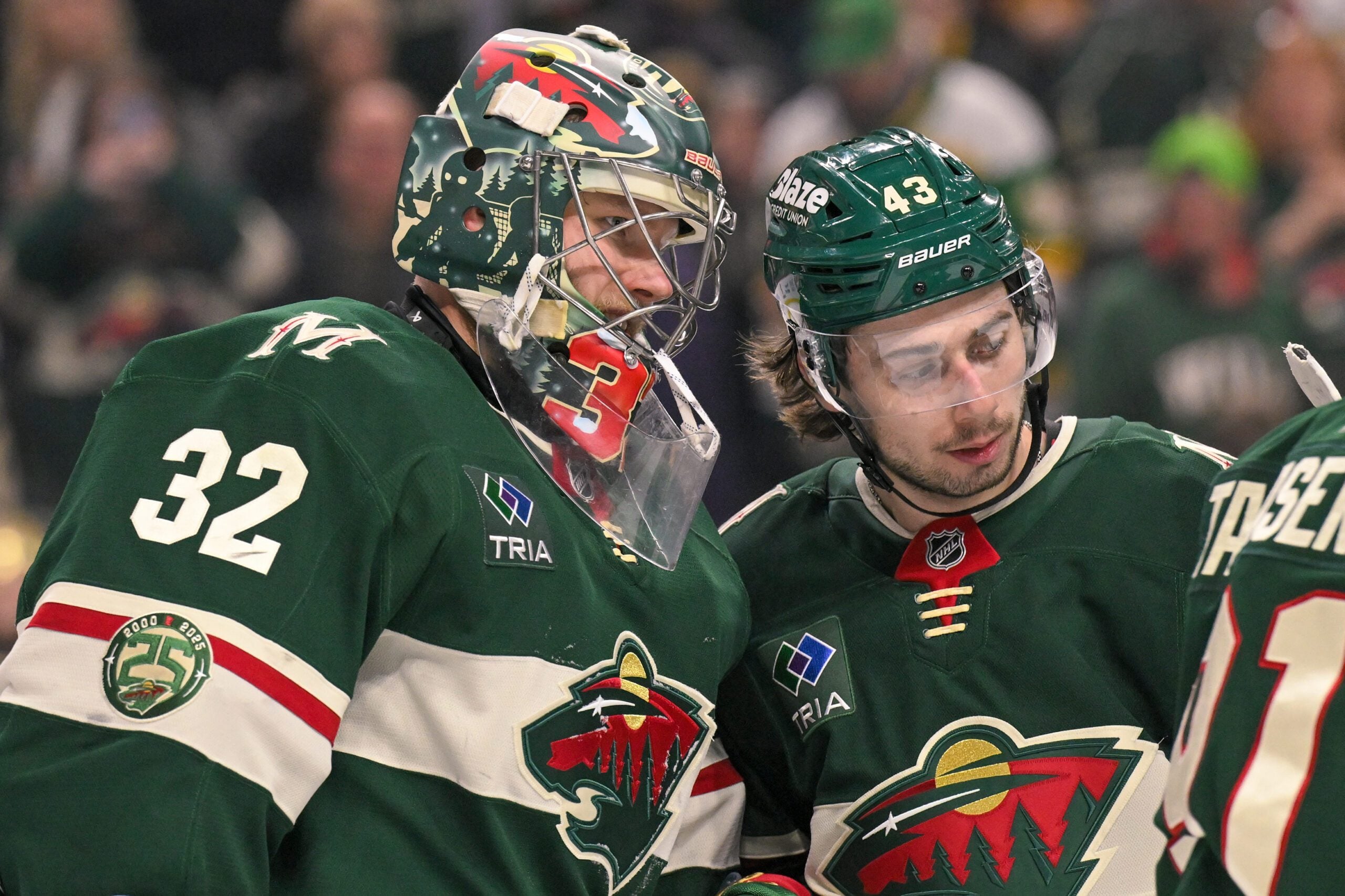 Dec 14, 2025; Saint Paul, Minnesota, USA; Minnesota Wild goalie Filip Gustavsson (32) and defensemen Quinn Hughes (43) celebrate a victory over the Boston Bruins at Grand Casino Arena. Mandatory Credit: Nick Wosika-Imagn Images
