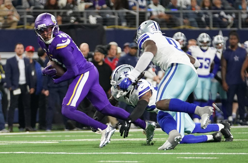 Dec 14, 2025; Arlington, Texas, USA; Minnesota Vikings wide receiver Justin Jefferson (18) runs against Dallas Cowboys safety Malik Hooker (28) and linebacker Demarvion Overshown (0) during the second half at AT&T Stadium. Mandatory Credit: Raymond Carlin III-Imagn Images