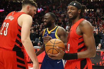 Dec 14, 2025; Portland, Oregon, USA; Portland Trail Blazers forward Jerami Grant (9) reacts after the game as center Donovan Clingan (23) talks with Golden State Warriors forward Draymond Green (23) at Moda Center. Mandatory Credit: Jaime Valdez-Imagn Images