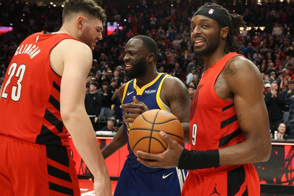 Dec 14, 2025; Portland, Oregon, USA; Portland Trail Blazers forward Jerami Grant (9) reacts after the game as center Donovan Clingan (23) talks with Golden State Warriors forward Draymond Green (23) at Moda Center. Mandatory Credit: Jaime Valdez-Imagn Images
