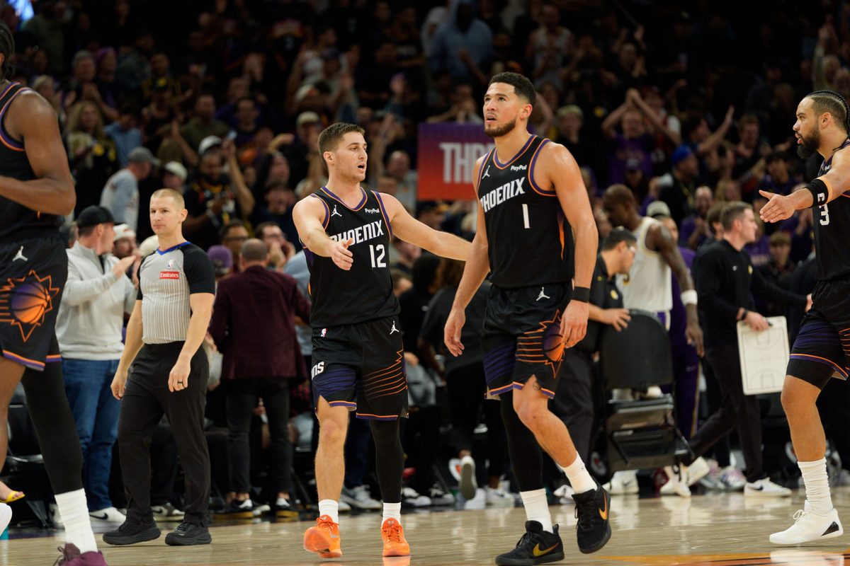 Dec 14, 2025; Phoenix, Arizona, USA; Phoenix Suns guard Devin Booker (1) and guard Collin Gillespie (12) react after the Sun take the lead late in the second half of a game against the Los Angeles Lakers at Mortgage Matchup Center. Mandatory Credit: Allan Henry-Imagn Images