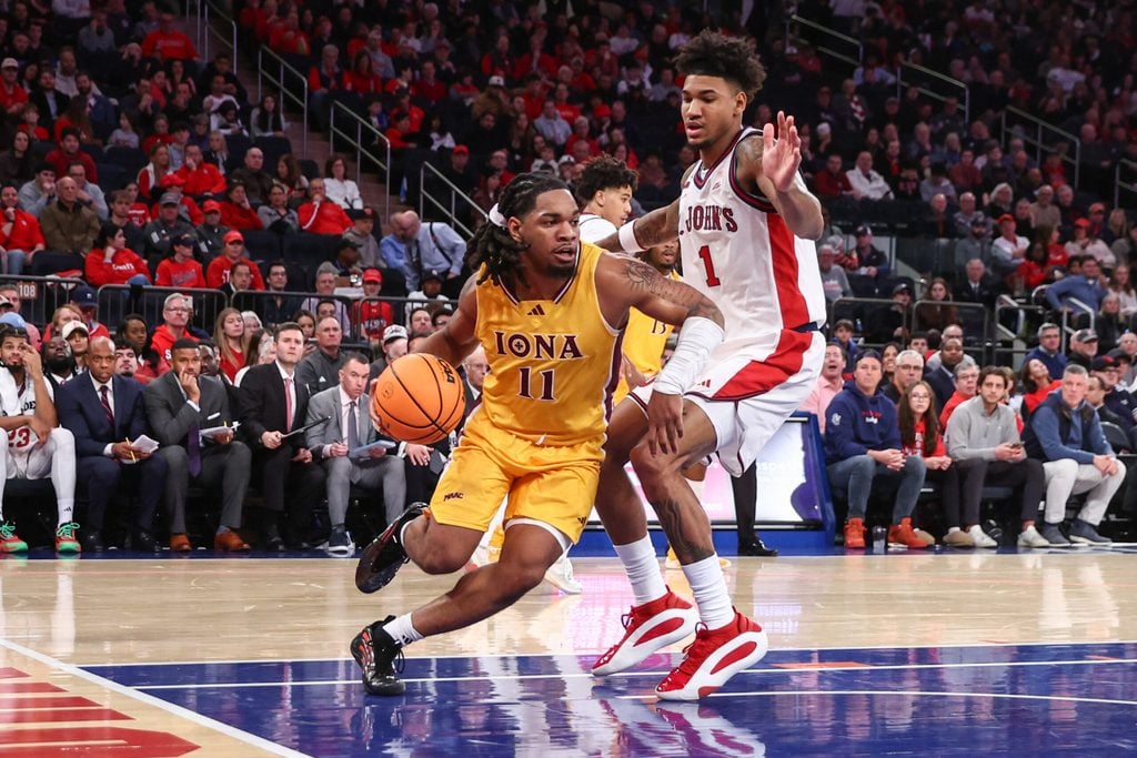 Dec 13, 2025; Queens, New York, USA; Iona Gaels guard C.J. Anthony (11) and St. John's Red Storm forward Dillon Mitchell (1) at Madison Square Garden. Mandatory Credit: Wendell Cruz-Imagn Images