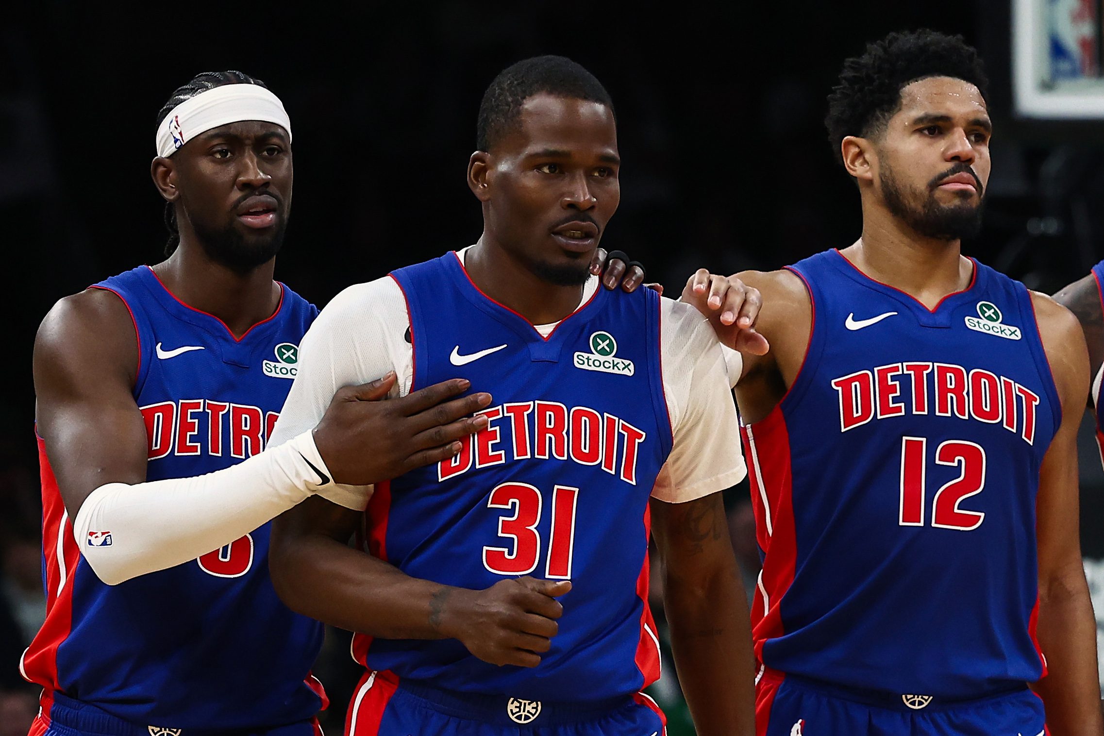 Dec 15, 2025; Boston, Massachusetts, USA; Teammates Detroit Pistons forward Tobias Harris (12) and guard Caris Levert (8) go over to guard Javonte Green (31) after he was called for a technical foul against the Boston Celtics during the second half at TD Garden. Mandatory Credit: Winslow Townson-Imagn Images
