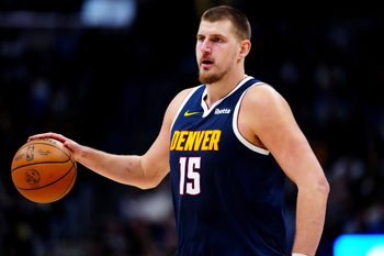 Dec 15, 2025; Denver, Colorado, USA; Denver Nuggets center Nikola Jokic (15) controls the ball in the fourth quarter against the Houston Rockets at Ball Arena. Mandatory Credit: Ron Chenoy-Imagn Images