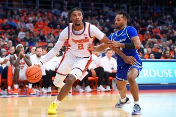 Dec 17, 2025; Syracuse, New York, USA; Syracuse Orange guard J.J. Starling (2) drives against Mercyhurst Lakers guard Bernie Blunt (4) during the second half at the JMA Wireless Dome. Mandatory Credit: Rich Barnes-Imagn Images
