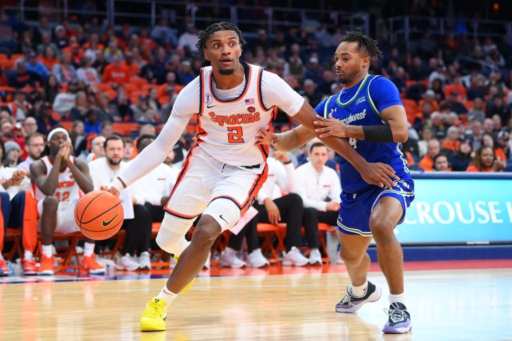 Dec 17, 2025; Syracuse, New York, USA; Syracuse Orange guard J.J. Starling (2) drives against Mercyhurst Lakers guard Bernie Blunt (4) during the second half at the JMA Wireless Dome. Mandatory Credit: Rich Barnes-Imagn Images