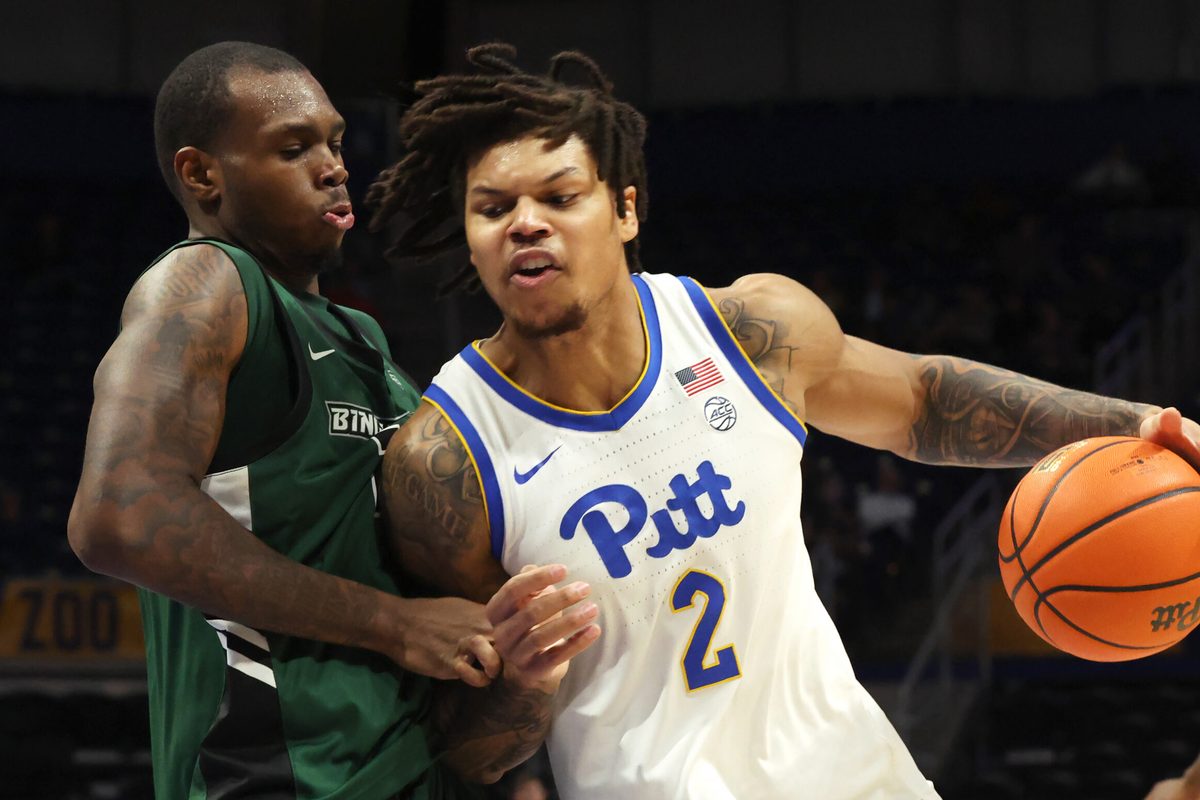 Dec 17, 2025; Pittsburgh, Pennsylvania, USA;  Pittsburgh Panthers forward Cameron Corhen (2) dribbles the ball against pressure from Binghamton Bearcats center Demetrius Lilley (left) during the second half at the Petersen Events Center. Mandatory Credit: Charles LeClaire-Imagn Images