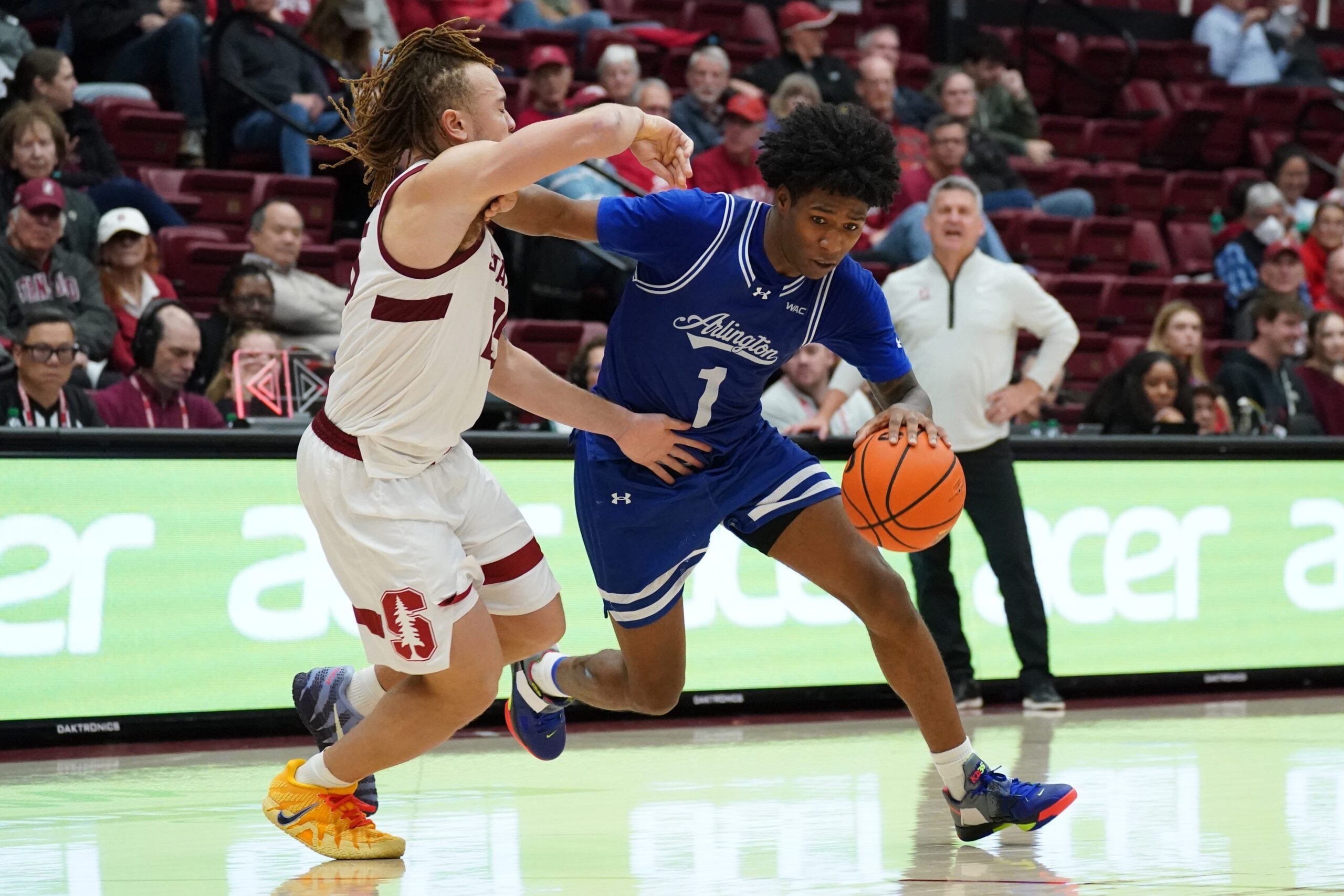 Dec 17, 2025; Stanford, California, USA;  Texas-Arlington Mavericks guard Cash Chavis (1) drives on Stanford Cardinal guard Jeremy Dent-Smith (25) in the second half at Maples Pavilion. Mandatory Credit: David Gonzales-Imagn Images