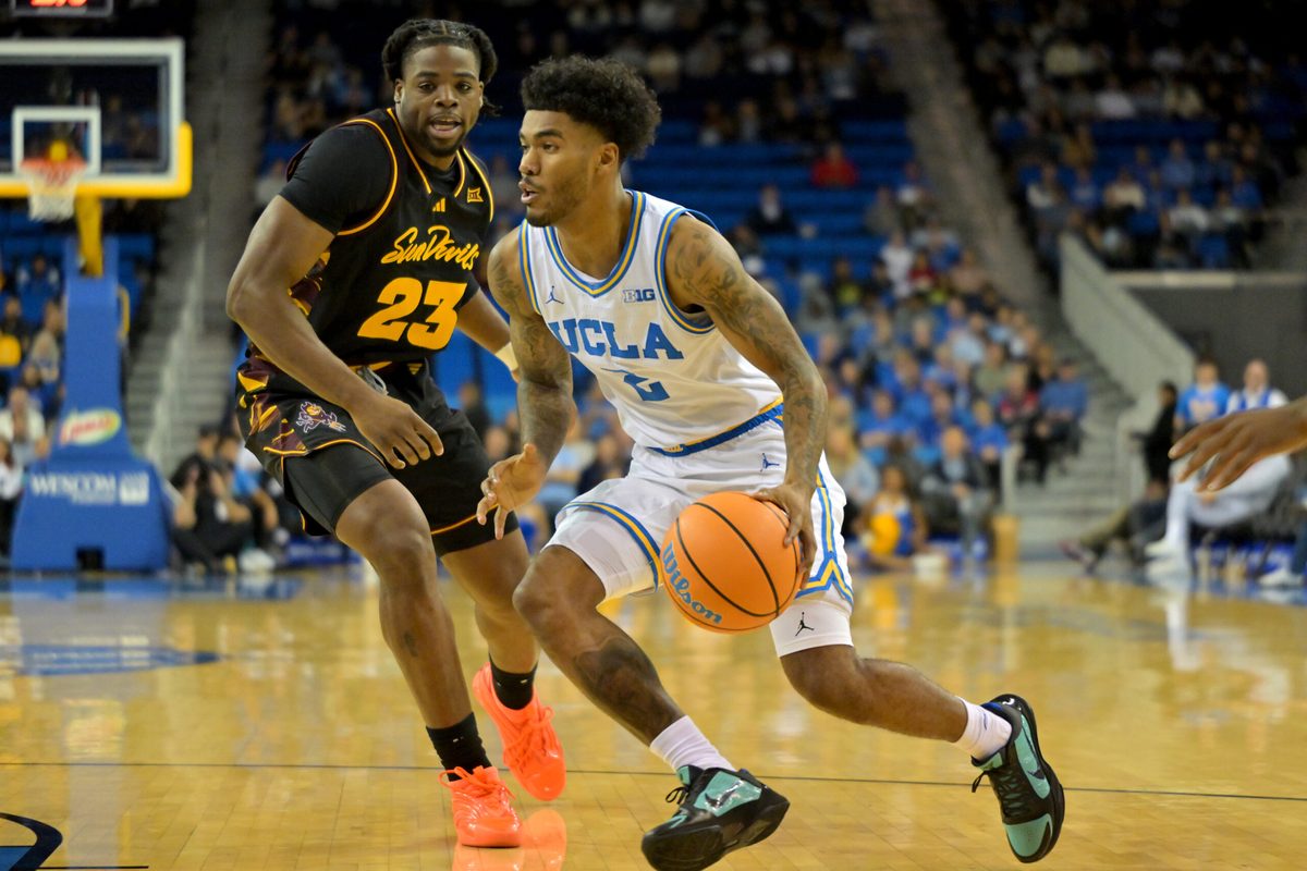 Dec 17, 2025; Los Angeles, California, USA; UCLA Bruins guard Donovan Dent (2) drives past Arizona State Sun Devils forward Allen Mukeba (23) in the first half at Pauley Pavilion presented by Wescom Financial. Mandatory Credit: Jayne Kamin-Oncea-Imagn Images
