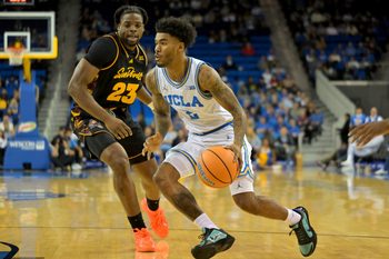 Dec 17, 2025; Los Angeles, California, USA; UCLA Bruins guard Donovan Dent (2) drives past Arizona State Sun Devils forward Allen Mukeba (23) in the first half at Pauley Pavilion presented by Wescom Financial. Mandatory Credit: Jayne Kamin-Oncea-Imagn Images