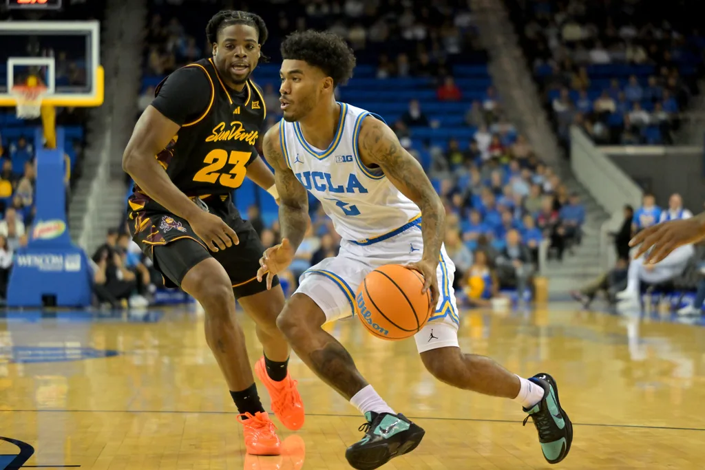 Dec 17, 2025; Los Angeles, California, USA; UCLA Bruins guard Donovan Dent (2) drives past Arizona State Sun Devils forward Allen Mukeba (23) in the first half at Pauley Pavilion presented by Wescom Financial. Mandatory Credit: Jayne Kamin-Oncea-Imagn Images