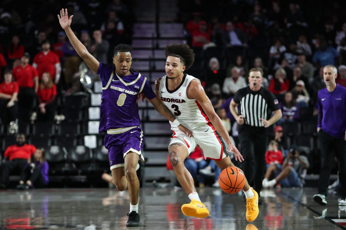 Dec 18, 2025; Athens, Georgia, USA; Georgia Bulldogs guard Jordan Ross (3) dribbles past Western Carolina Catamounts guard Tahlan Pettway (8) in the second half at Stegeman Coliseum. Mandatory Credit: Mady Mertens-Imagn Images