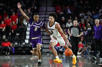 Dec 18, 2025; Athens, Georgia, USA; Georgia Bulldogs guard Jordan Ross (3) dribbles past Western Carolina Catamounts guard Tahlan Pettway (8) in the second half at Stegeman Coliseum. Mandatory Credit: Mady Mertens-Imagn Images