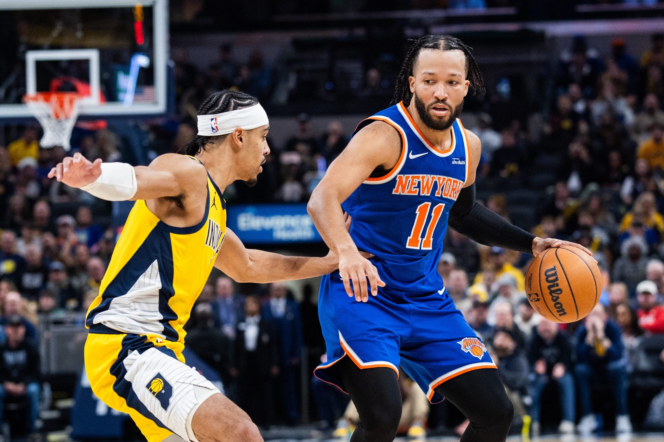 Dec 18, 2025; Indianapolis, Indiana, USA;  New York Knicks guard Jalen Brunson (11) dribbles the ball while  Indiana Pacers guard/forward Andrew Nembhard (2) defends in the second half at Gainbridge Fieldhouse. Mandatory Credit: Trevor Ruszkowski-Imagn Images