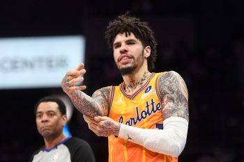 Dec 18, 2025; Charlotte, North Carolina, USA;  Charlotte Hornets guard LaMelo Ball (1) rubs his elbow after falling during the second half against the Atlanta Hawks at the Spectrum Center. Mandatory Credit: Sam Sharpe-Imagn Images