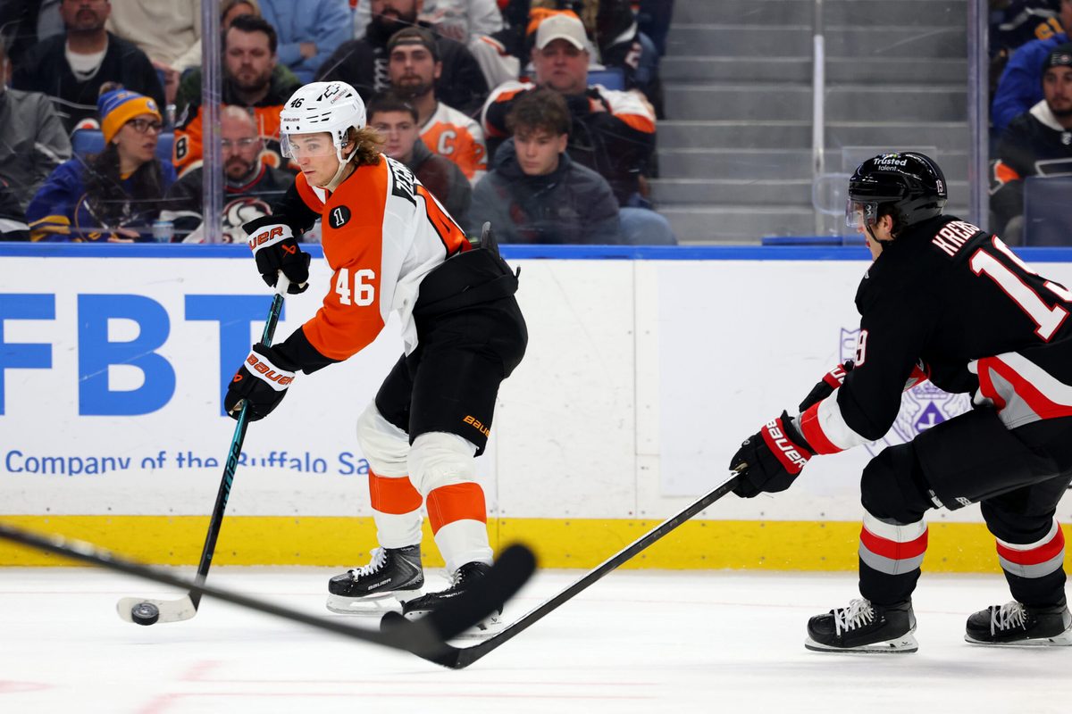 Dec 18, 2025; Buffalo, New York, USA;  Philadelphia Flyers center Trevor Zegras (46) makes a pass as Buffalo Sabres center Peyton Krebs (19) tries to block it during the third period at KeyBank Center. Mandatory Credit: Timothy T. Ludwig-Imagn Images