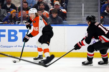 Dec 18, 2025; Buffalo, New York, USA;  Philadelphia Flyers center Trevor Zegras (46) makes a pass as Buffalo Sabres center Peyton Krebs (19) tries to block it during the third period at KeyBank Center. Mandatory Credit: Timothy T. Ludwig-Imagn Images