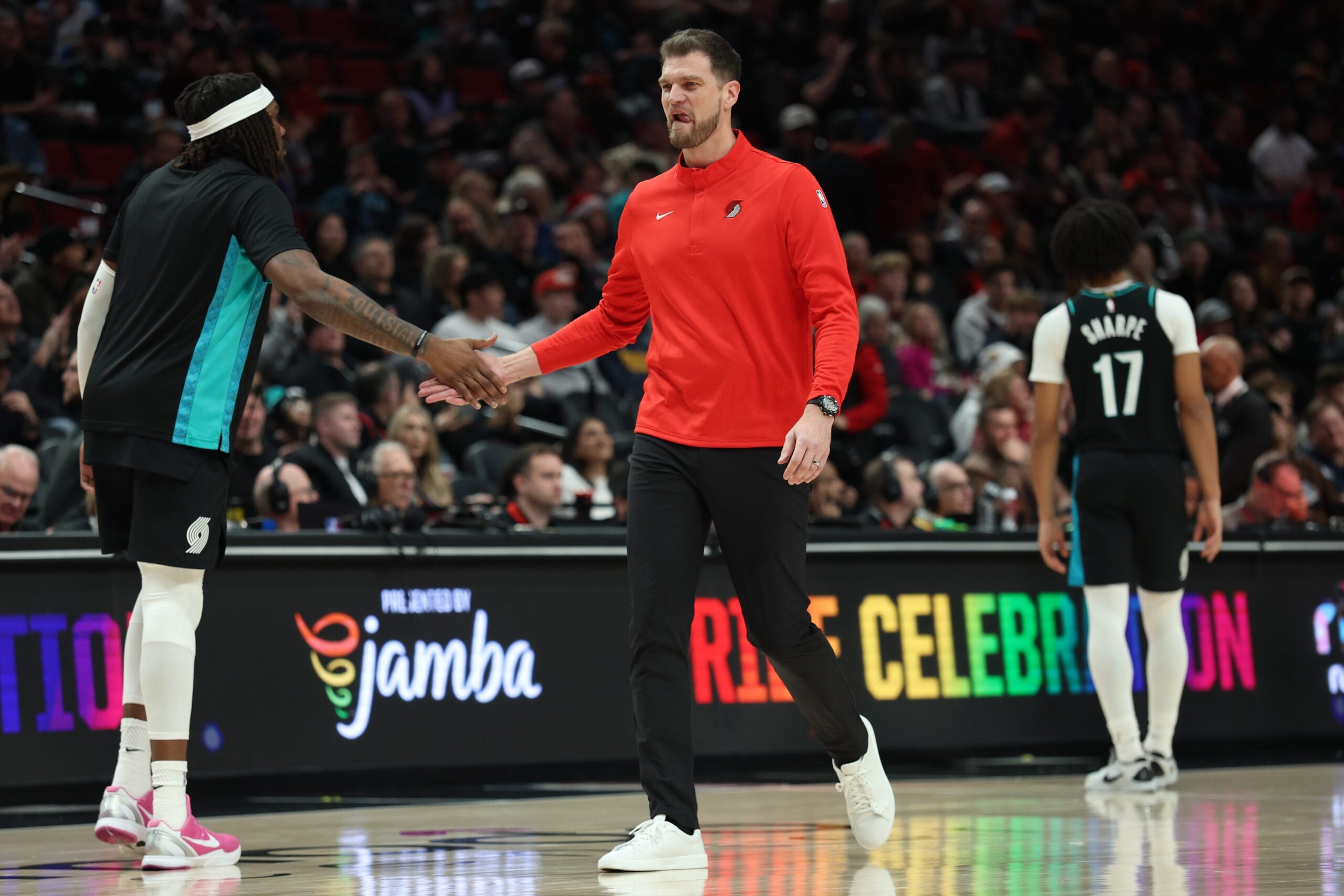 Dec 18, 2025; Portland, Oregon, USA;  Portland Trail Blazers Interim Head Coach Tiago Splitter slaps the hand of Portland Trail Blazers center/forward Robert Williams III (35) during the second half at Moda Center. Mandatory Credit: Jaime Valdez-Imagn Images