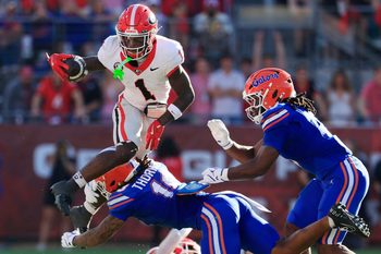 (EDITOR’S NOTE: Resubmitted with alternate crop.) Georgia Bulldogs wide receiver Zachariah Branch (1) leaps while being shoved out of bounds by Florida Gators defensive back Bryce Thornton (18) while picking up a third down during the second quarter of an NCAA football game, Saturday, Nov. 1, 2025, at EverBank Stadium in Jacksonville, Fla. Georgia held off Florida 24-20.