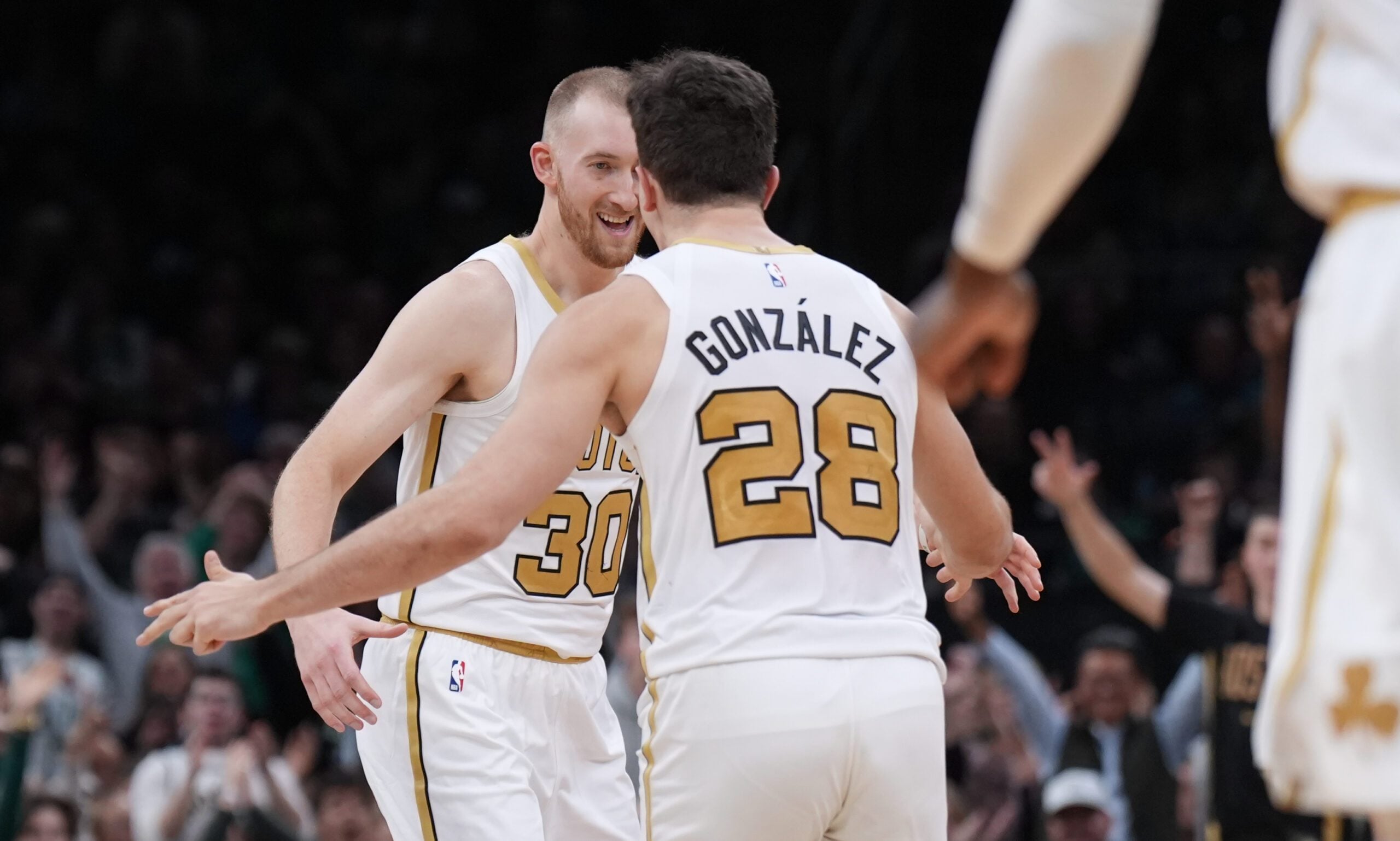 Dec 19, 2025; Boston, Massachusetts, USA; Boston Celtics forward Sam Hauser (30) reacts after his three point basket with guard Hugo Gonzalez (28) against the Miami Heat in the second half at TD Garden. Mandatory Credit: David Butler II-Imagn Images