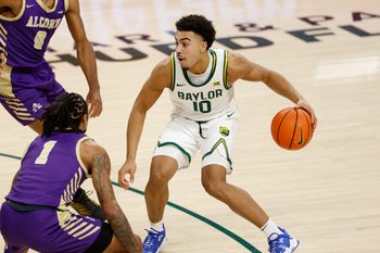 Dec 19, 2025; Waco, Texas, USA;  Baylor Bears guard Isaac Williams (10) dribbles between Alcorn State Braves guard Shane Lancaster (0) and guard Jameel Morris (1) during the second half at Paul and Alejandra Foster Pavilion. Mandatory Credit: Chris Jones-Imagn Images