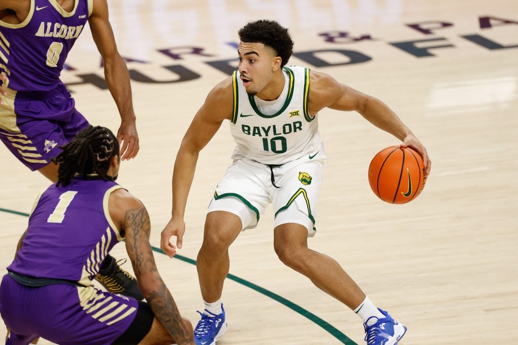 Dec 19, 2025; Waco, Texas, USA; Baylor Bears guard Isaac Williams (10) dribbles between Alcorn State Braves guard Shane Lancaster (0) and guard Jameel Morris (1) during the second half at Paul and Alejandra Foster Pavilion. Mandatory Credit: Chris Jones-Imagn Images