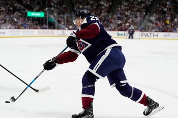Dec 19, 2025; Denver, Colorado, USA; Colorado Avalanche center Nathan MacKinnon (29) takes a shot on goal in the second period against the Winnipeg Jets at Ball Arena. Mandatory Credit: Ron Chenoy-Imagn Images