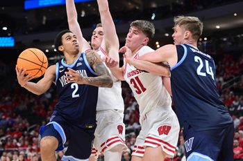 Dec 19, 2025; Milwaukee, Wisconsin, USA; Villanova Wildcats guard Bryce Lindsay (2) takes a shot against Wisconsin Badgers forward Nolan Winter (31) in the second half at the Fiserv Forum. Mandatory Credit: Benny Sieu-Imagn Images