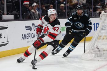 Dec 19, 2025; Salt Lake City, Utah, USA; New Jersey Devils defenseman Luke Hughes (43) plays the puck against Utah Mammoth center Kevin Stenlund (82) during the third period at Delta Center. Mandatory Credit: Rob Gray-Imagn Images
