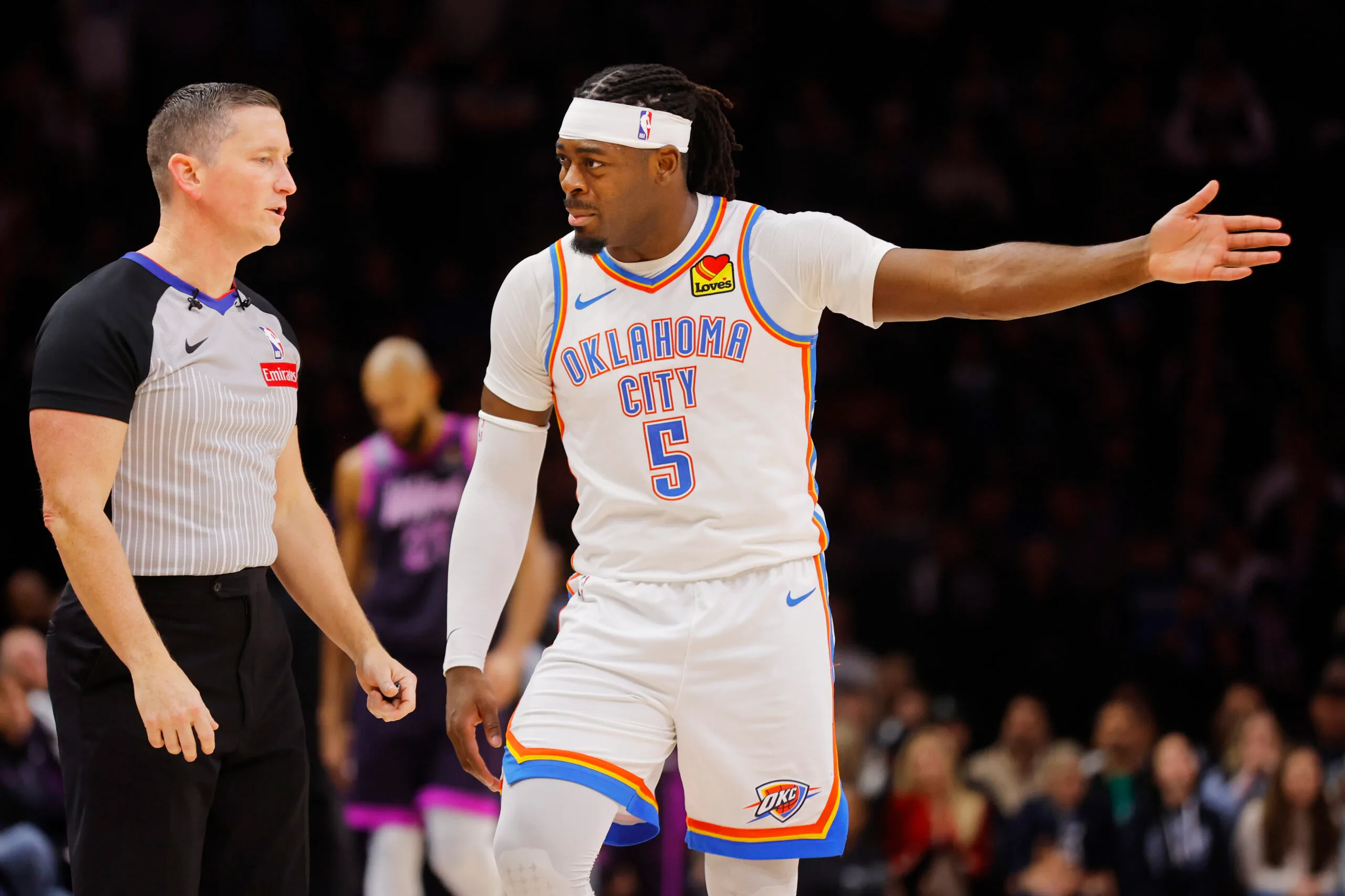 Dec 19, 2025; Minneapolis, Minnesota, USA; Oklahoma City Thunder forward Luguentz Dort (5) questions referee Nick Buchert on a call for the Minnesota Timberwolves in the fourth quarter at Target Center. Mandatory Credit: Bruce Kluckhohn-Imagn Images