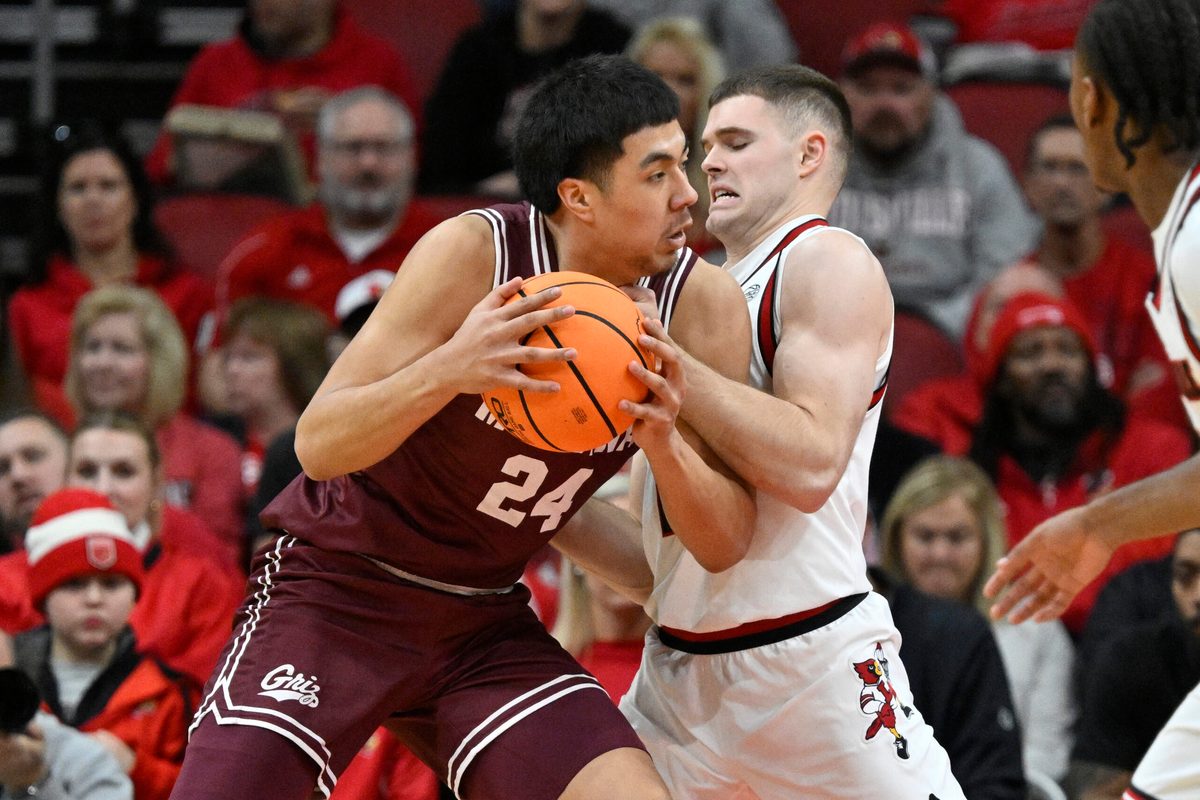 Dec 20, 2025; Louisville, Kentucky, USA;  Montana Grizzlies forward Kenyon Aguino (24) posts up against Louisville Cardinals guard Isaac McKneely (10) during the first half at KFC Yum! Center. Mandatory Credit: Jamie Rhodes-Imagn Images