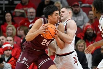 Dec 20, 2025; Louisville, Kentucky, USA;  Montana Grizzlies forward Kenyon Aguino (24) posts up against Louisville Cardinals guard Isaac McKneely (10) during the first half at KFC Yum! Center. Mandatory Credit: Jamie Rhodes-Imagn Images