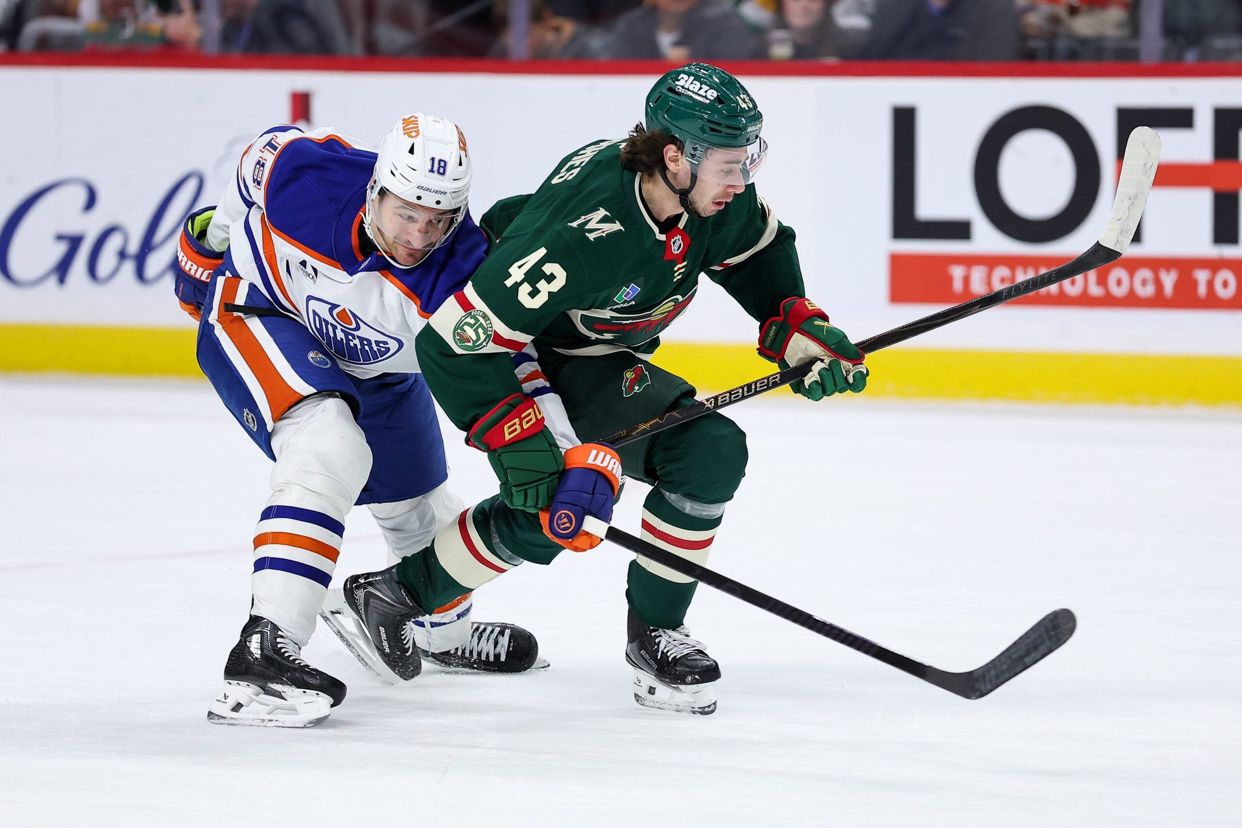 Dec 20, 2025; Saint Paul, Minnesota, USA; Minnesota Wild defenseman Quinn Hughes (43) and Edmonton Oilers left wing Zach Hyman (18) compete for the puck during the first period at Grand Casino Arena. Mandatory Credit: Matt Krohn-Imagn Images