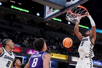Dec 20, 2025; Indianapolis, Indiana, USA; Butler Bulldogs forward Michael Ajayi (5) dunks the ball against Northwestern Wildcats forward Tre Singleton (8) during the second half at Gainbridge Fieldhouse. Mandatory Credit: Robert Goddin-Imagn Images