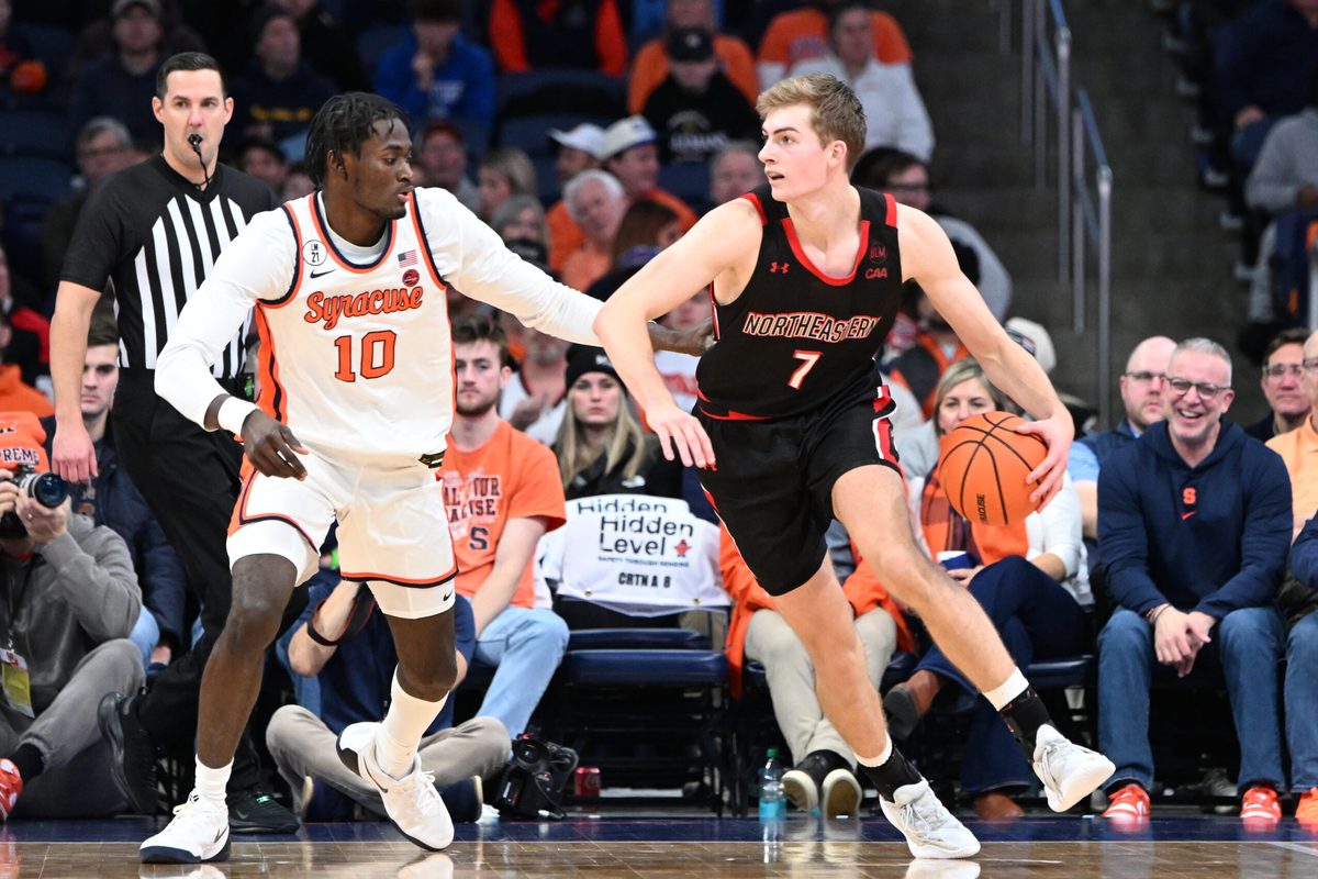 Dec 20, 2025; Syracuse, New York, USA; Northeastern Huskies forward Youri Fritz (7) handles the ball against Syracuse Orange forward Ibrahim Souare (10) in the second half at the JMA Wireless Dome. Mandatory Credit: Mark Konezny-Imagn Images
