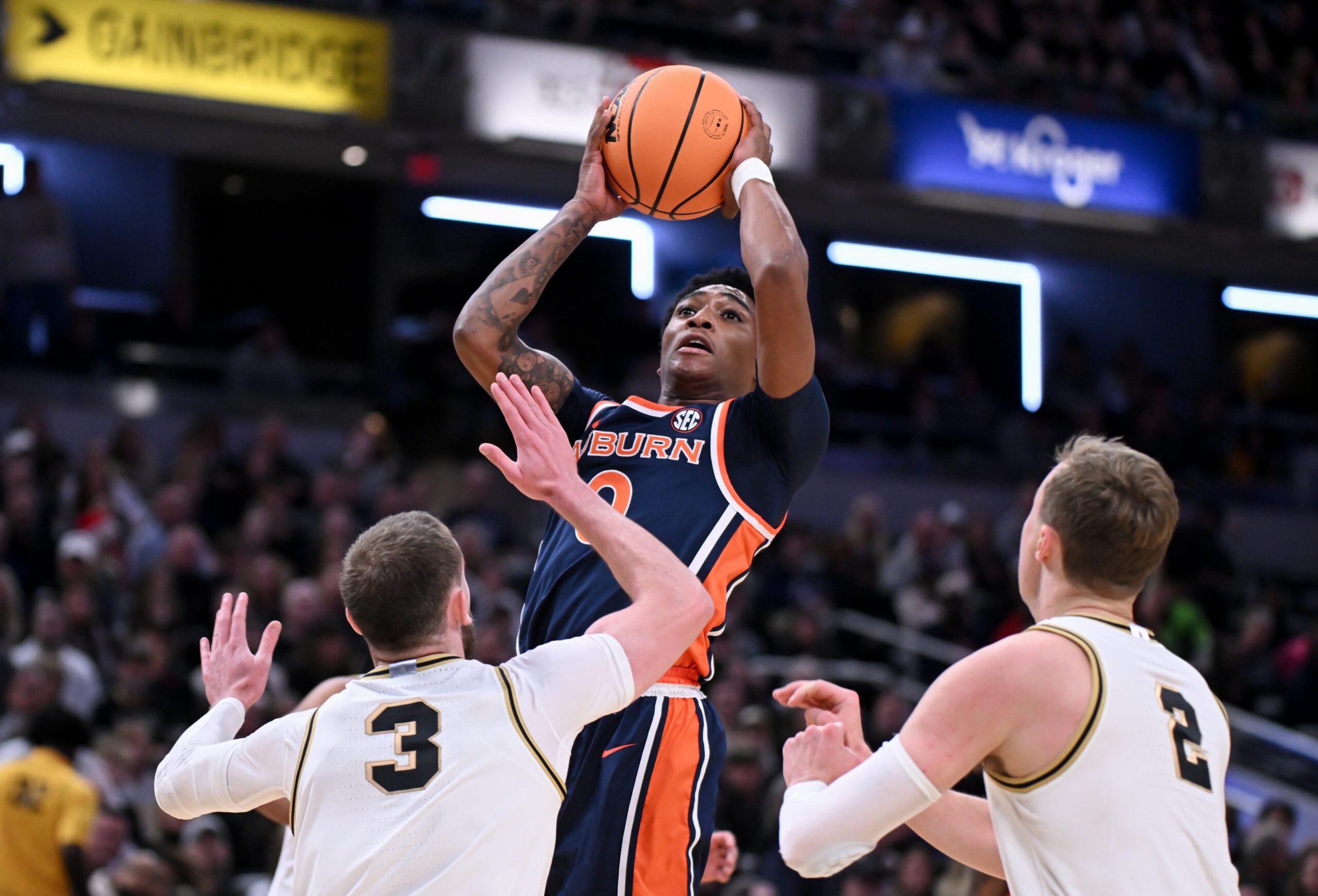Dec 20, 2025; Indianapolis, Indiana, USA; Auburn Tigers guard Tahaad Pettiford (0) shoots the ball past Purdue Boilermakers guard Braden Smith (3) during the first half at Gainbridge Fieldhouse. Mandatory Credit: Robert Goddin-Imagn Images
