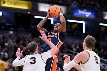 Dec 20, 2025; Indianapolis, Indiana, USA; Auburn Tigers guard Tahaad Pettiford (0) shoots the ball past Purdue Boilermakers guard Braden Smith (3) during the first half at Gainbridge Fieldhouse. Mandatory Credit: Robert Goddin-Imagn Images