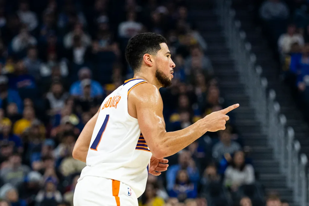 Dec 20, 2025; San Francisco, California, USA; Phoenix Suns guard Devin Booker (1) reacts after he hit a three-point shot against the Golden State Warriors during the first quarter at Chase Center. Mandatory Credit: John Hefti-Imagn Images