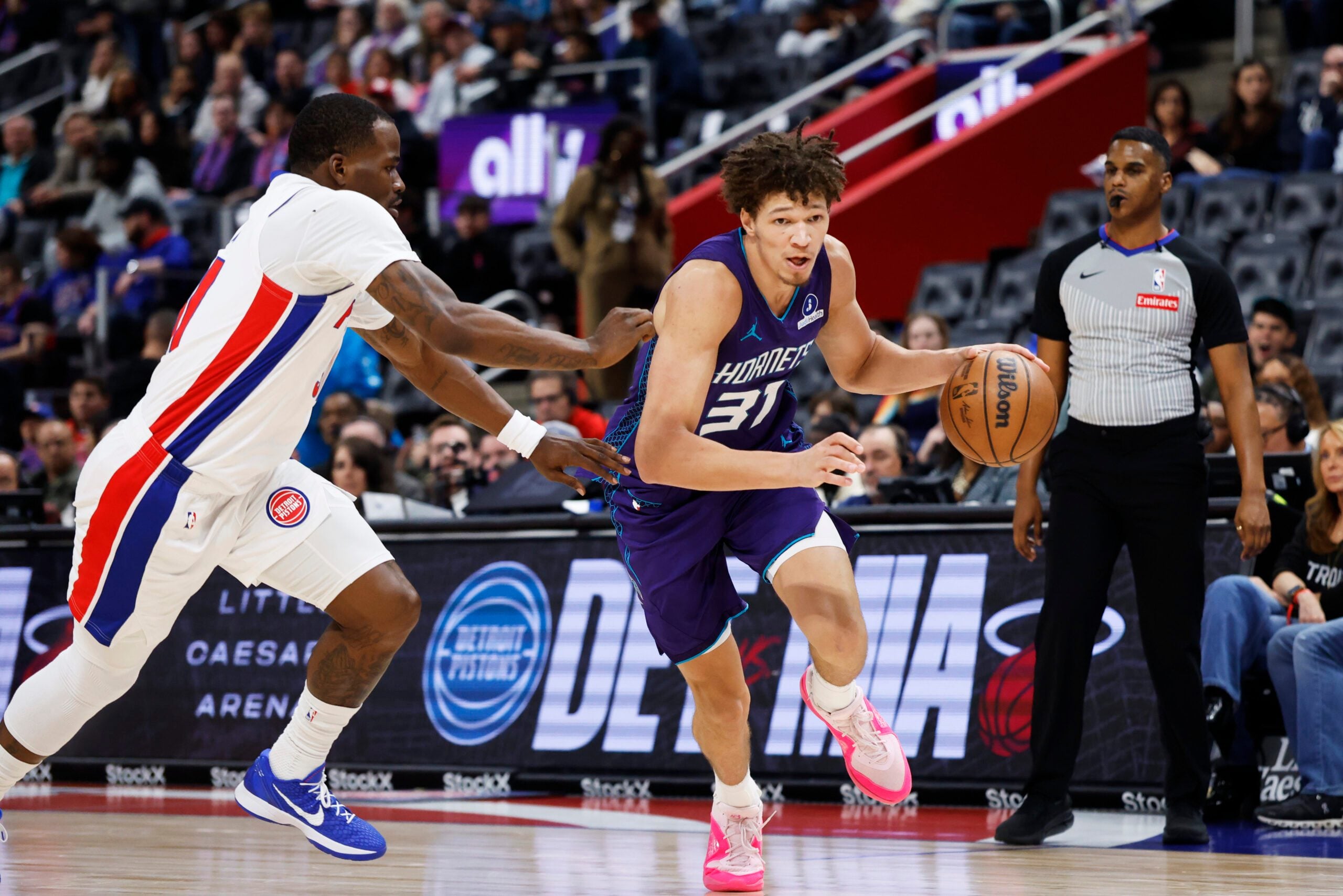 Dec 20, 2025; Detroit, Michigan, USA; Charlotte Hornets forward Tidjane Salaun (31) dribbles defended by Detroit Pistons guard Javonte Green (31) in the second half at Little Caesars Arena. Mandatory Credit: Rick Osentoski-Imagn Images