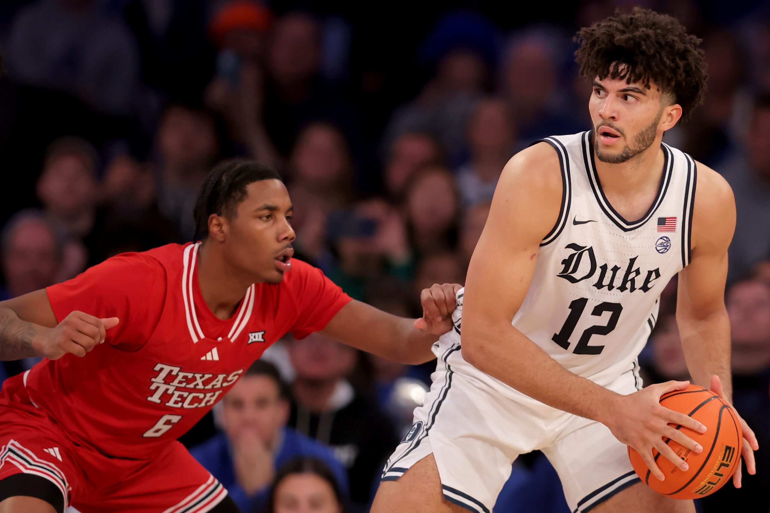 Dec 20, 2025; New York, New York, USA; Duke Blue Devils forward Cameron Boozer (12) controls the ball against Texas Tech Red Raiders guard Leon Horner (6) during the second half at Madison Square Garden. Mandatory Credit: Brad Penner-Imagn Images