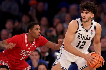Dec 20, 2025; New York, New York, USA; Duke Blue Devils forward Cameron Boozer (12) controls the ball against Texas Tech Red Raiders guard Leon Horner (6) during the second half at Madison Square Garden. Mandatory Credit: Brad Penner-Imagn Images