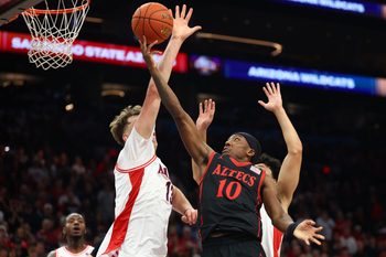 Dec 20, 2025; Phoenix, Arizona, USA; San Diego State Aztecs guard BJ Davis (10) drives to the basket against the Arizona Wildcats in the first half during the Hall of Fame Series at Mortgage Matchup Center. Mandatory Credit: Mark J. Rebilas-Imagn Images