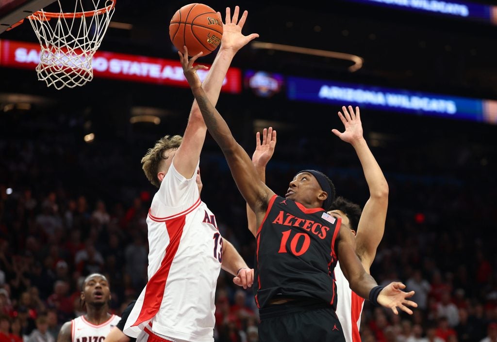 Dec 20, 2025; Phoenix, Arizona, USA; San Diego State Aztecs guard BJ Davis (10) drives to the basket against the Arizona Wildcats in the first half during the Hall of Fame Series at Mortgage Matchup Center. Mandatory Credit: Mark J. Rebilas-Imagn Images